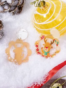 Detail of Christmas reindeer acrylic earrings with festive pine cones and snow decor