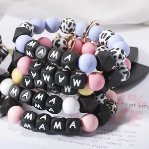 Detail of colorful silicone beads with leopard print and black MAMA letter beads