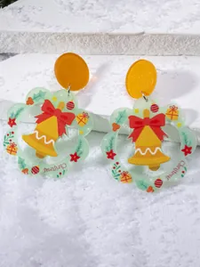 Detail of Christmas earrings featuring glitter studs and acrylic bell pendants