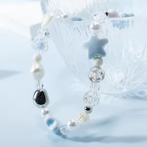 Handmade beaded phone strap with ice blue stars, white pearls, and silver metal beads