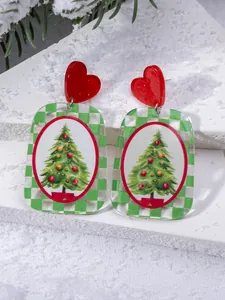 Close-up of Christmas tree acrylic earrings with red heart studs and checkered border
