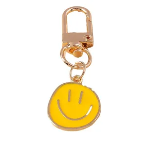 Cartoon yellow smiley face keychain with golden metal clasp and enamel round pendant
