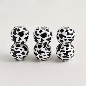 Detailed view of round cow print wooden beads with holes for DIY craft jewelry making