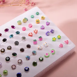 Close-up of mixed colorful fruit and animal resin stud earrings with crystals on display