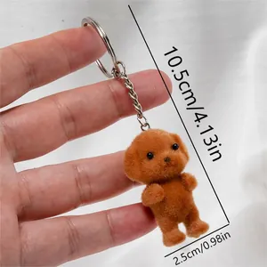 Detail view of brown flocked poodle keychain showing 10.5cm length with metal ring