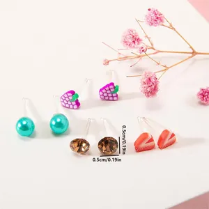Detail view of colorful fruit and heart stud earrings with resin pins for kids