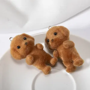 Macro detail of brown flocked poodle keychains with realistic soft texture on white cloth