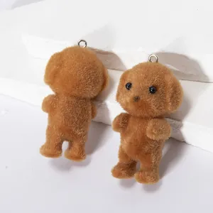 Detailed view of two brown flocked poodle keychains with soft texture and metal rings