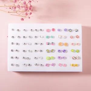 Close-up of 36 pairs of colorful resin fruit and rhinestone stud earrings set for kids