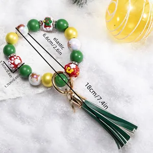 Detail of Christmas silicone bead bracelet with green tassels and santa charms
