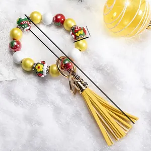 Detailed view of Christmas silicone bead keychain with dimension specs and yellow tassel