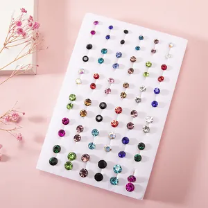 Detailed macro view of 36 pairs colorful resin rhinestone stud earrings on white display card