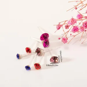Macro detail of 0.6cm hypoallergenic resin stud earrings with colorful faux gemstones