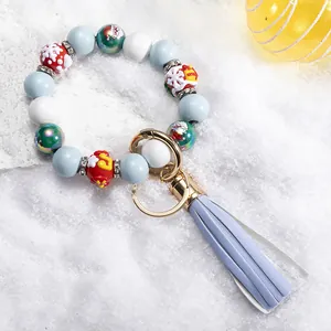 Christmas silicone bead wristlet keychain with Santa pattern, blue tassel, and metal ring