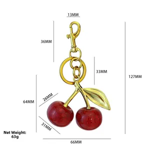 Detail of red glitter cherry keychain with gold metal leaf and 127mm total length