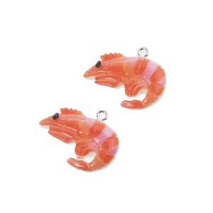 Macro detail of realistic orange resin shrimp charms for DIY keychain making