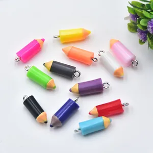 Detailed view of colorful mini resin pencil charms with silver rings for DIY jewelry craft