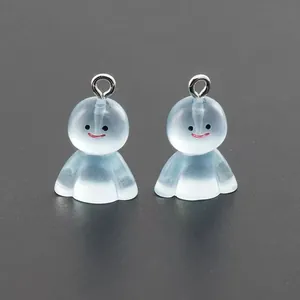 Macro shot of two blue translucent resin Japanese Teru Teru Bozu charms with silver rings