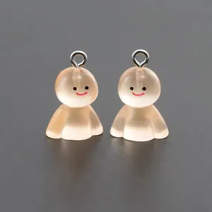 Close-up of translucent resin ghost pendants with smiling faces and silver metal rings