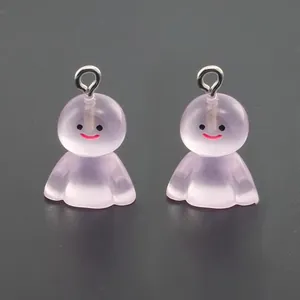 Close-up of two light purple translucent resin ghost charms with smiling faces for DIY crafts
