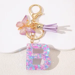 Pink sequin resin letter B keychain with purple butterfly and leather tassel charms