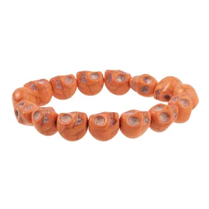 Macro shot of orange skull beads with detailed vintage crackle texture for Halloween