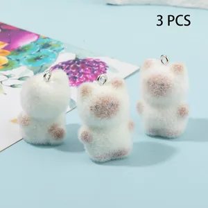 Detailed view of three flocked Siamese cat pendants with metal loops for DIY jewelry