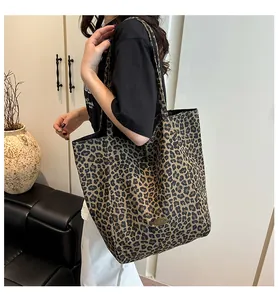 Detailed view of fashionable leopard print tote bag worn on shoulder for style check