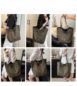 Close-up of leopard print canvas tote bag with metal logo detail and sturdy handles