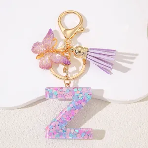 Close-up of resin letter Z keychain with pink sequins and purple butterfly tassel