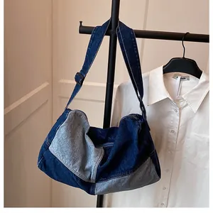 Detail of blue denim patchwork tote bag showing adjustable strap and large capacity