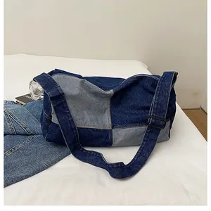Detailed view of large capacity vintage denim patchwork crossbody bag with wide strap