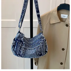 Macro detail of snowflake blue denim bag with zipper pockets and decorative drawstrings