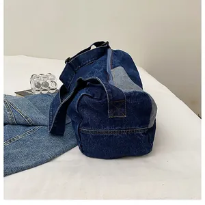 Detail of blue denim tote bag with reinforced stitching and adjustable shoulder strap