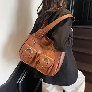 Retro caramel brown PU leather tote bag with silver rings shown on a fashion model