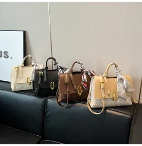 Detail view of woven handbags in four colors with gold U-shaped buckles and silk scarves