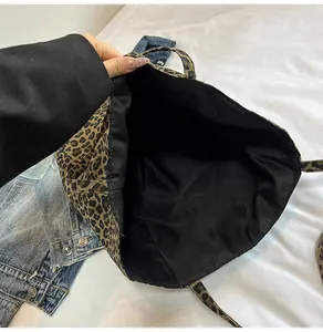 Detail shot of leopard print tote bag interior showing durable black fabric lining
