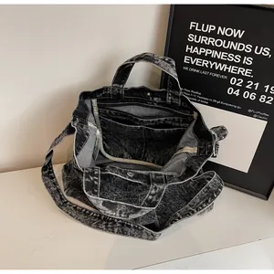 Detail of the large denim tote interior featuring a zipper pocket and spacious compartments