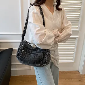 Retro black washed denim dumpling bag with multi-pocket design and adjustable strap