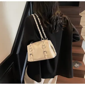 Detail of cream Boston shoulder bag with silver chain strap and buckle accents