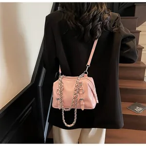 Light pink shiny PU leather handbag with silver chain detail on model back view