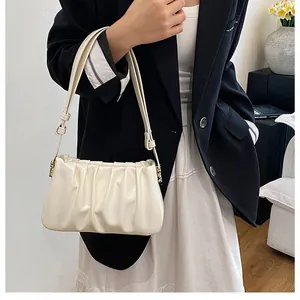 Detailed close-up showing the soft pleated texture of the cream cloud shoulder bag