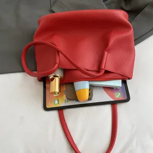 Red pebbled leather tote bag showing large capacity for tablet and daily essentials