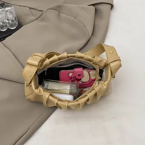 French vintage beige pleated shoulder bag showing spacious interior with personal items