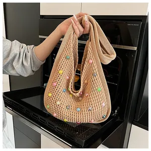 Detailed knit texture of khaki crochet tote bag featuring multi-colored acrylic beads decoration
