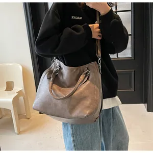 Close-up of the dark brown lychee texture tote bag with detachable shoulder strap details