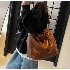 Close-up of vintage brown tote bag with retro leather texture and dual shoulder straps