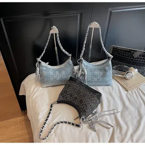 Detail view of denim and tweed chain bags with cannage stitching and metal charms