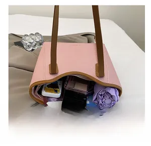 Internal capacity of pink tote bag showing tablet, umbrella, and phone inside