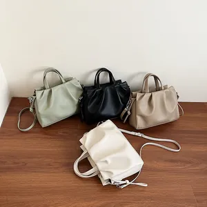 Fashionable ruched crossbody bag with top handle and adjustable strap in four soft colors